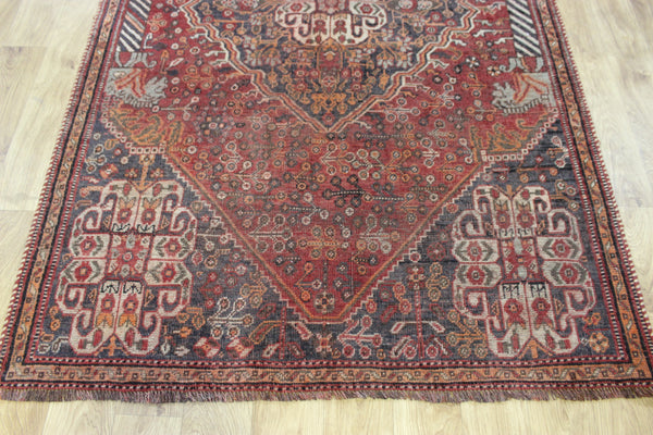 Antique Persian Qashqai rug with a large medallion design 215 x 130 cm