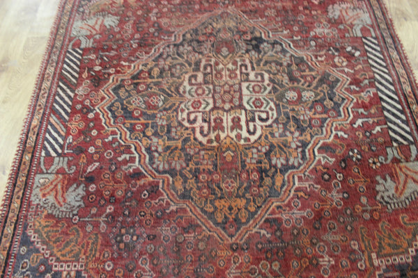 Antique Persian Qashqai rug with a large medallion design 215 x 130 cm