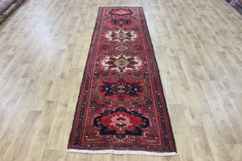 An outstanding handmade Persian Heriz runner of traditional medallion design 280 x 80 cm
