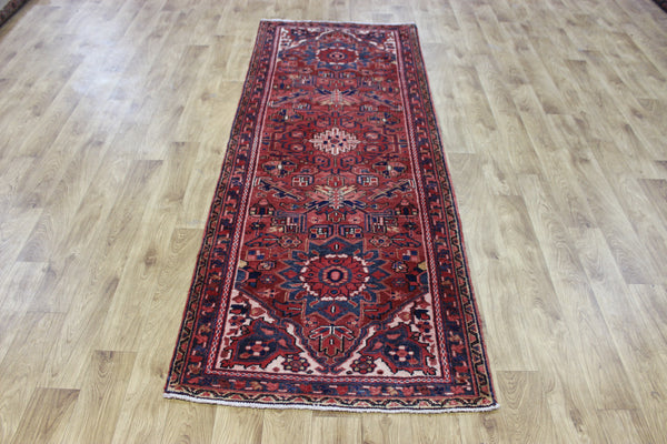 A good Persian Heriz runner of traditional medallion design 235 x 90 cm