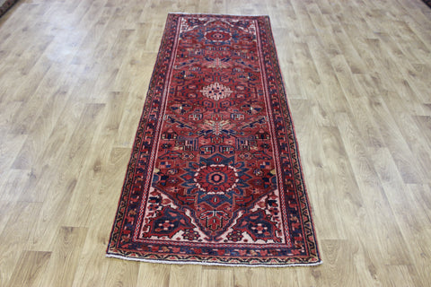 A good Persian Heriz runner of traditional medallion design 235 x 90 cm