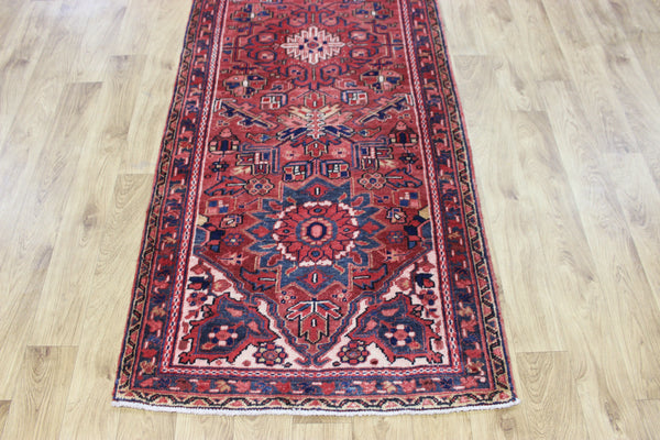 A good Persian Heriz runner of traditional medallion design 235 x 90 cm