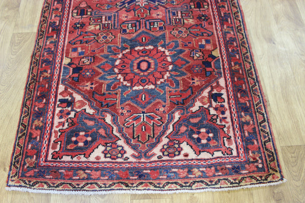 A good Persian Heriz runner of traditional medallion design 235 x 90 cm