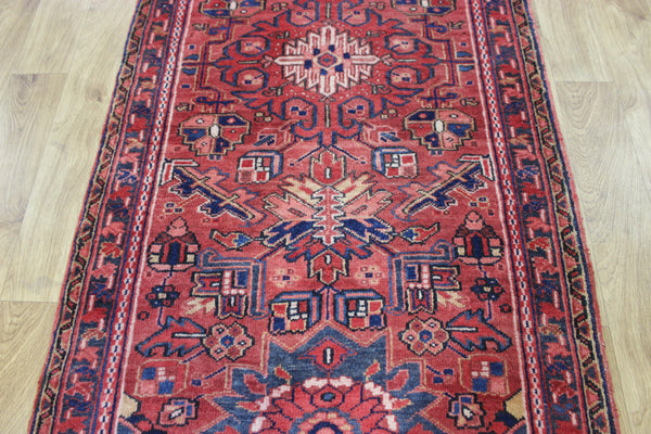A good Persian Heriz runner of traditional medallion design 235 x 90 cm