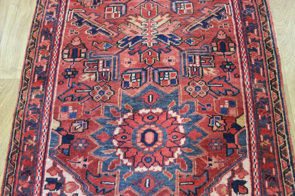 A good Persian Heriz runner of traditional medallion design 235 x 90 cm