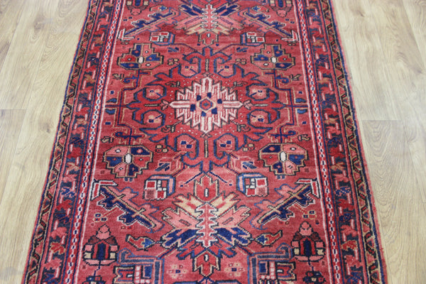 A good Persian Heriz runner of traditional medallion design 235 x 90 cm