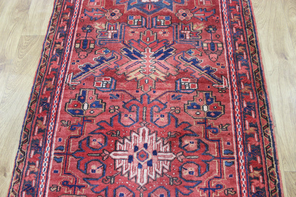 A good Persian Heriz runner of traditional medallion design 235 x 90 cm