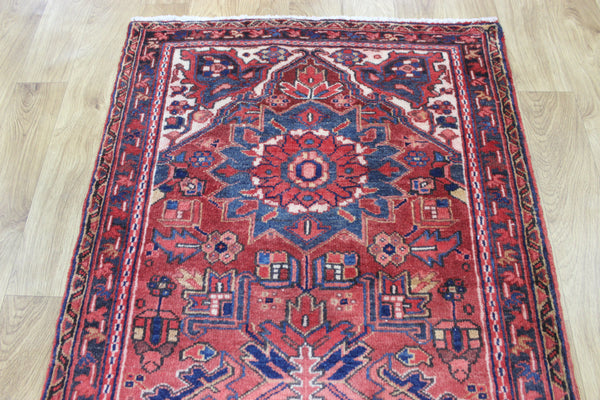 A good Persian Heriz runner of traditional medallion design 235 x 90 cm