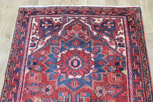 A good Persian Heriz runner of traditional medallion design 235 x 90 cm