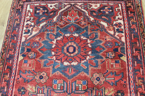 A good Persian Heriz runner of traditional medallion design 235 x 90 cm