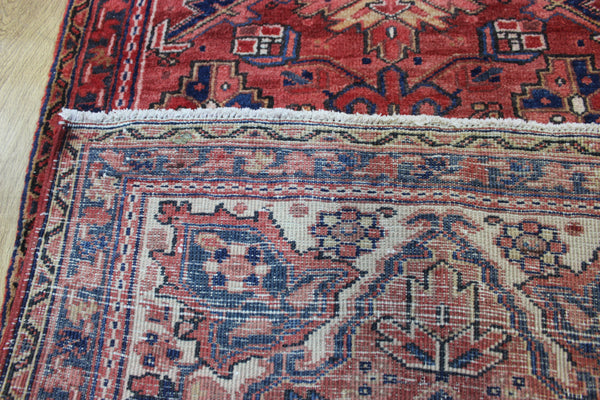 A good Persian Heriz runner of traditional medallion design 235 x 90 cm