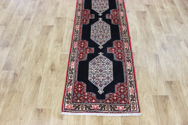 A traditional Persian Bidjar runner of traditional medallion design 247 x 56 cm
