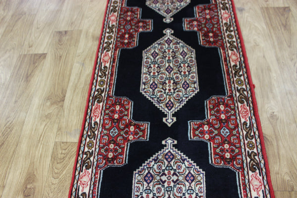 A traditional Persian Bidjar runner of traditional medallion design 247 x 56 cm