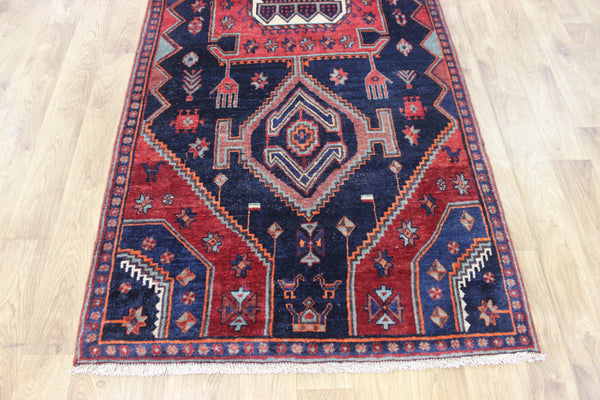 Old handmade Persian Hamadan region runner of traditional medallion design. Dated to the field 1349 (1976).
