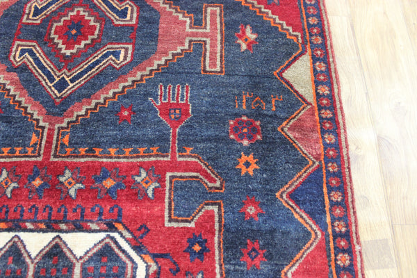 Old handmade Persian Hamadan region runner of traditional medallion design. Dated to the field 1349 (1976).