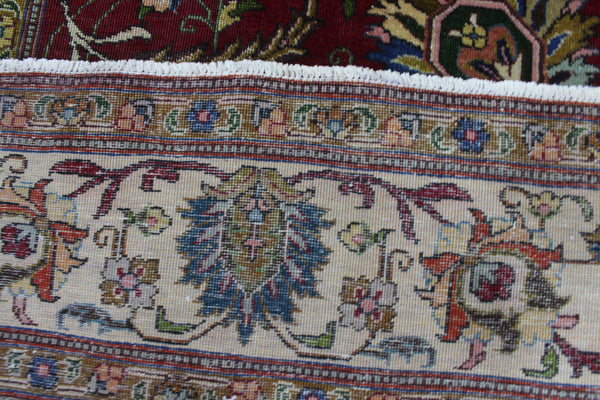 SIGNED PERSIAN TABRIZ CARPET WITH A LARGE SCALE FLORAL DESIGN 330 X 240 CM